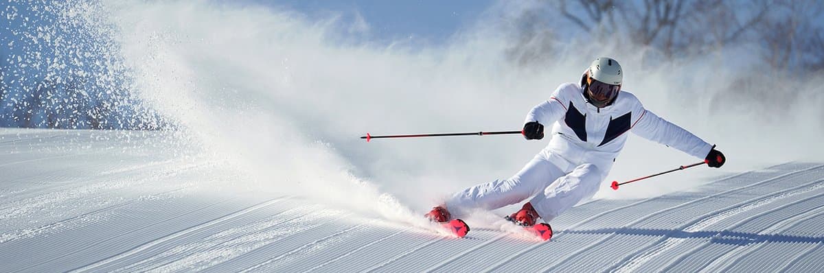 Catherine Snow's dynamic winter sports photograph capturing a skier mid-flight against pristine powder snow