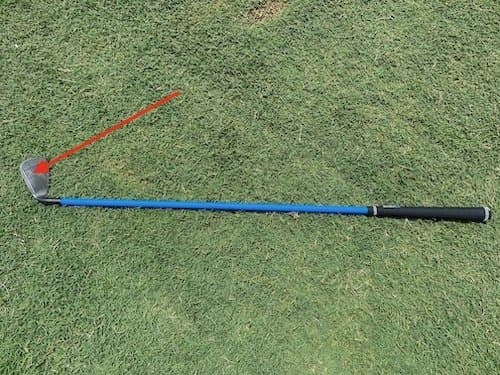 Orange Whip trainer demonstrating proper swing sequence with weighted design and flexible shaft