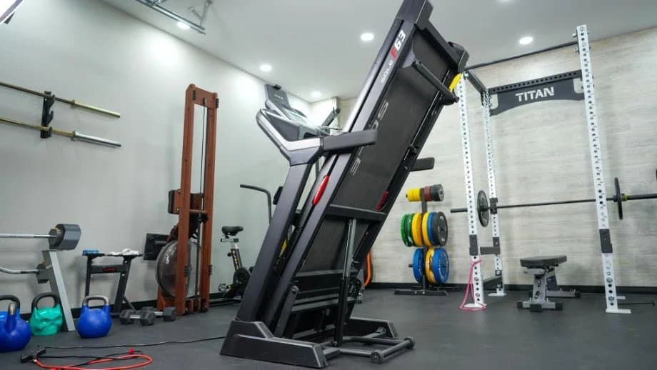 Sole F63 treadmill in home gym showing its sturdy construction and folding capability
