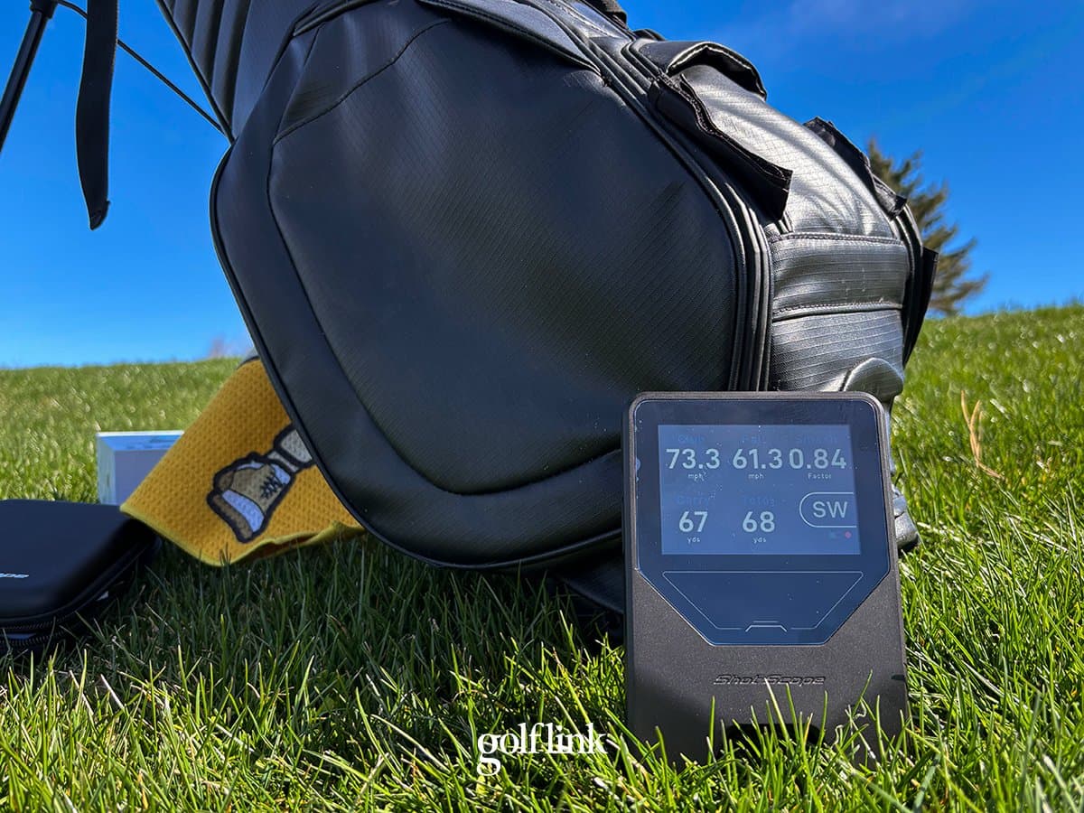 Shot Scope LM1 launch monitor and rangefinder combination device on golf tee box