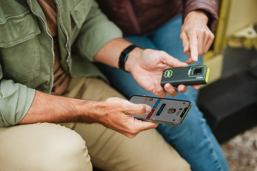 ACR Bivy Stick connected to smartphone displaying app interface on camping gear